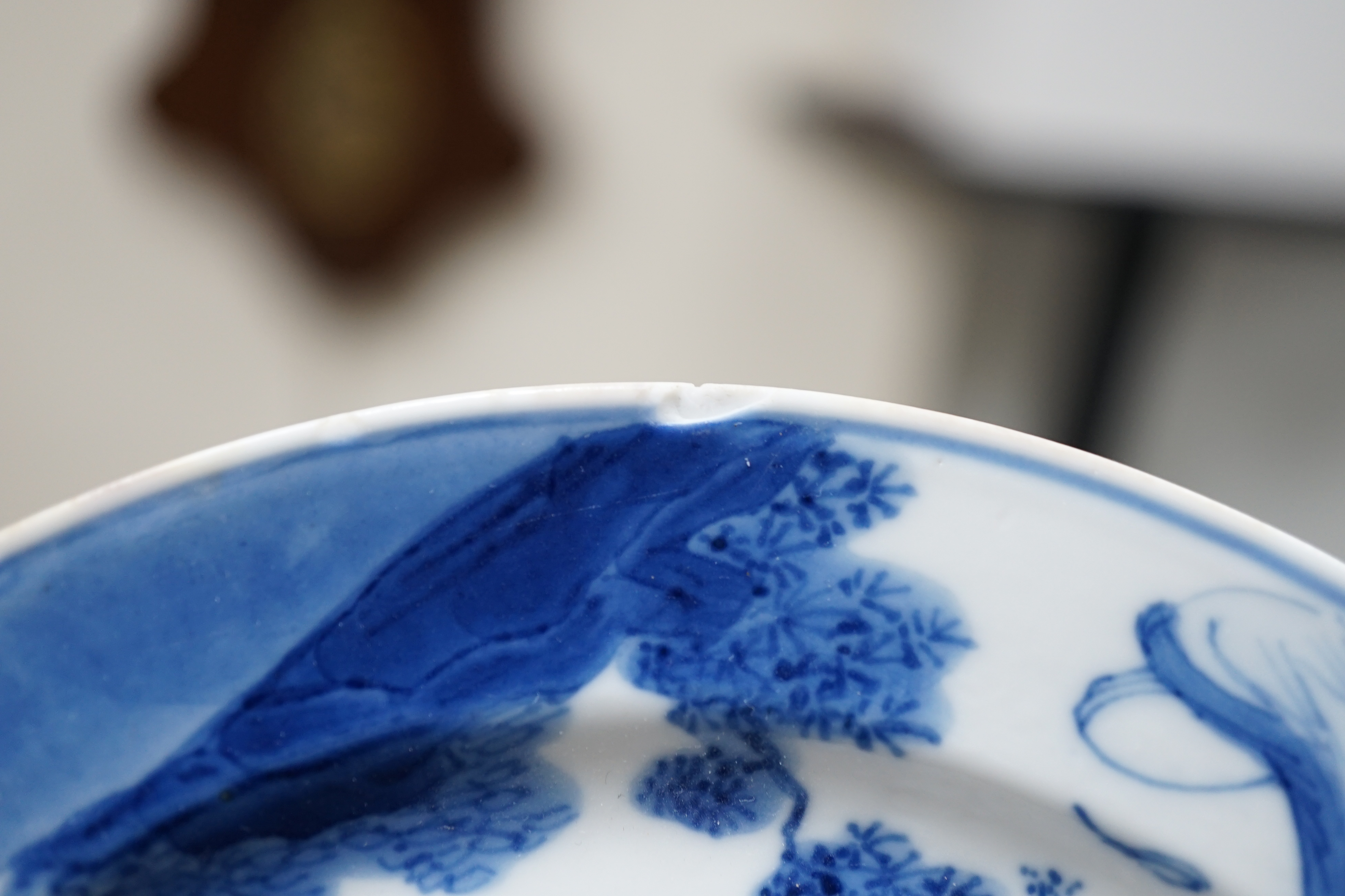 A pair of Chinese blue and white small plates, Kangxi period, hairline cracks to one plate.